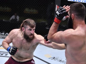 In this handout image provided by UFC, Tanner Boser, left, punches Andrei Arlovski of Belarus in a heavyweight fight during the UFC Fight Night event at UFC APEX on Nov. 07, 2020, in Las Vegas, Nevada.