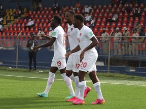 Canada's Alphonso Davies, 19, Cyle Larin, 17 and Jonathan David, 20, celebrate a goal against Haiti in World Cup qualifying in Port-au-Prince, Haiti on June 12, 2021. Canada won 1-0.