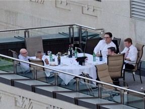 Jason Kenney and some cabinet ministers are pictured a patio in the Federal Building in Edmonton on Tuesday, June 1, 2021. From the top right is Environment and Parks Minister Jason Nixon, Health Minister Tyler Shandro and Kenney with his back to the camera.