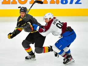 Vegas Golden Knights defenseman Brayden McNabb (3) eyes the puck while taking a check from Colorado Avalanche right wing Mikko Rantanen (96) during the first period of game four of the second round of the 2021 Stanley Cup Playoffs at T-Mobile Arena on June 6, 2021.