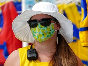 Lifeguard Eliza Rasmussen follows pandemic health restrictions by wearing a face mask at Queen Elizabeth Outdoor Pool in Edmonton on Monday, June 14, 2021, when the pool opened to the public.