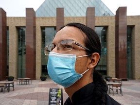 Austin Contois-Crane wears a face mask outside Edmonton City Hall on Tuesday June 22, 2021. Edmonton city council passed the first two readings of a proposed bylaw amendment to suspend the mandatory mask requirement as of July 1. The final reading will be voted on Friday.