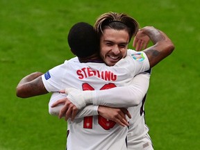 England's forward Raheem Sterling celebrates scoring the opening goal with his teammate England's midfielder Jack Grealish during the UEFA EURO 2020 Group D football match between Czech Republic and England at Wembley Stadium in London on June 22, 2021.
