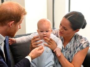 Prince Harry, Duke of Sussex and Meghan, Duchess of Sussex tend to their baby son Archie Mountbatten-Windsor at a meeting with Archbishop Desmond Tutu at the Desmond & Leah Tutu Legacy Foundation during their royal tour of South Africa on September 25, 2019 in Cape Town, South Africa.