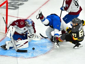 Colorado Avalanche centre Nathan MacKinnon (29) trips over Vegas Golden Knights left-wing Max Pacioretty (67) as Avalanche goaltender Philipp Grubauer (31) makes a save in Game 3 of their second-round playoff series at T-Mobile Arena in Las Vegas on Friday, June 4, 2021.
