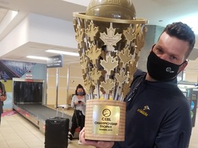 Edmonton Stingers president Brett Fraser arrives at the Edmonton International Airport on Aug. 10 with the Canadian Elite Basketball League championship trophy in hand after the club won the Summer Series in St. Catharines, Ont.