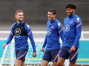 England's Jordan Henderson, Conor Coady and Tyrone Mings during training at St. George's Park in Burton upon Trent, Britain on June 24, 2021.