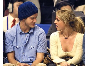 In this file photo taken on February 09, 2002 Pop superstars Britney Spears (R) and boyfriend Justin Timberlake (L) talk as they sit courtside at the NBA All-Star Game in Philadelphia.