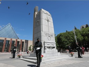Members of the 408 Tactical Helicopter Squadron fly over Edmonton City Hall during a ceremony rededicating the Edmonton Cenotaph in honour of Afghan War veterans, Sunday, June 13, 2021.