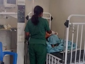 An infant who was injured in an air strike which killed dozens of people in the town of Tagogon in Ethiopia's Tigray region, is treated by a member of the medical staff at the Ayder Referral Hospital, in Mekelle, Ethiopia, June 23, 2021 in this handout picture obtained by REUTERS.