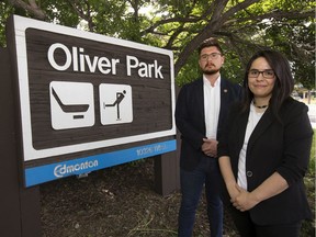Robyn Paches, Oliver Community League president, left, and Jacquelyn Cardinal, an Oliver resident from the Sucker Creek Cree First Nation, beside the Oliver Park sign at 10326 118 St. in Edmonton on Tuesday, June 23, 2020.