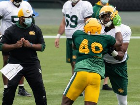 Thaddeus Coleman (50) and Shawn Lemon (40) go one-on-one during Edmonton Elks training camp at Commonwealth Stadium in Edmonton, on July 20, 2021. The team faces the Ottawa Redblacks in their first CFL game of the season at home on Aug. 7.