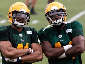 eishawn Bierria (44) strikes a pose with Kevin Brown II (41) and K during Edmonton Elks training camp at Commonwealth Stadium in Edmonton, on July 20.