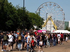 Fair fans lineup before the gates open on the Summer Fun Midway at the Edmonton Expo Centre grounds in Edmonton, on Friday, July 23, 2021. Photo by Ian Kucerak