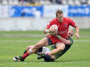 Harry Jones of Canada is tackled by Tim Anstee of Australia during the HSBC Rugby Sevens match between Australia and Canada on May 13, 2017, in Paris.