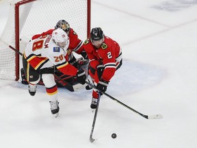 Calgary Flames center Elias Lindholm (28) battles for the puck with Chicago Blackhawks defenseman Duncan Keith (2) during the second period at United Center in    Chicago, Ill., on Jan 7, 2020.