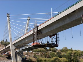 Workers construct the pedestrian walkway on the Tawatinâ LRT Bridge over the North Saskatchewan River on Monday, June 28, 2021. Photo by Ian Kucerak