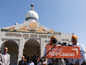 Gurpreet Kaur, centre, vice-president outreach for Sangat Youth, and Sital Nanuan, a Singh Sabha Gurdwara committee member, call for increased legal protection for their community as they face racist threats and actions during an Alberta NDP news conference at Singh Sabha Gurdwara in Edmonton on Wednesday, July 7, 2021.