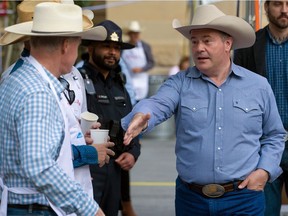 Alberta Premier Jason Kenney shakes hands with volunteers at the annual Premier's Stampede Breakfast in downtown Calgary on Monday, July 12, 2021. Kenney announced this week that equalization would be one of the referendum questions on the ballot in this fall's municipal election.