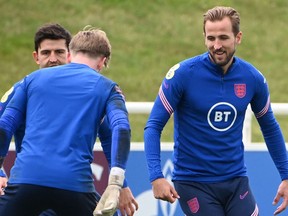 England's defender Harry Maguire (L), goalkeeper Jordan Pickford (C) and forward Harry Kane (R) attend an England training session at St George's Park in Burton-on-Trent, central England, on July 5, 2021.
