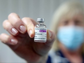 In this file photo taken on Jan. 4, 2021, a vial of the AstraZeneca/Oxford COVID-19 vaccine is held at the Pontcae Medical Practice in Merthyr Tydfil in south Wales.