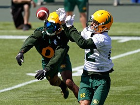 Defensive back Jonathan Rose (left) and receiver Greg Ellingson (right) reach for the ball during Edmonton Elks training camp at Commonwealth Stadium on July 12. The Elks hope Shai Ross (11) takes part in Edmonton Elks training camp at Commonwealth Stadium on July 27. The Elks hope they can run out the clock on the rest of their 10-day COVID quarantine and get back on the field to resume team activities Wednesday..