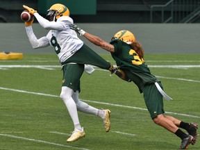 Wide receiver Kenny Stafford (8) makes the catch on defensive halfback Aaron Grymes (36) during Edmonton Elks training camp at Commonwealth Stadium in Edmonton on July 16, 2021.