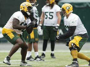 Edmonton's Kwabena Asare (62) and Colin Kelly (67) run a drill during practice at Commonwealth Stadium in Edmonton on Oct. 6, 2017.