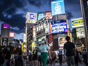 People wearing face masks cross Shibuya crossing on July 27, 2021 in Tokyo, Japan.
