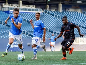 FC Edmonton striker Amer Didic (55) chases the loose ball as Christopher Nanco (11) of Forge FC defends at Investors Group Field in Winnipeg on July 1, 2021.