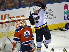 Edmonton Oilers goalie Cam Talbot (33) watches St. Louis Blues Vladimir Tarasenko (91) and Paul Stastny (26) celebrate a goal during the NHL season home opener at Rexall Place in Edmonton on Oct. 15, 2015.