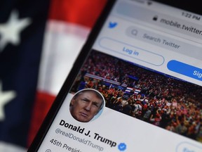 In this photo illustration, the Twitter account of U.S. President Donald Trump is displayed on a mobile phone in Arlington, Va., Aug. 10, 2020.