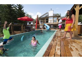 Rochelle Chamczuk, right, and her husband, Louis Babin, watch their children swim, including daughter Emily, 13.