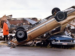 A police officer stands by some of the carnage on the southeast side of Edmonton after a massive tornado struck on Friday July 31, 1987. The tornado killed 27 people and injured hundreds, it also caused more than $330 million in property damage.