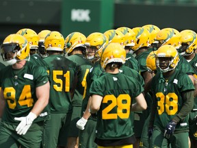 Players wait for instruction during Edmonton Elks training camp on Sunday, July 11, 2021, in Edmonton.