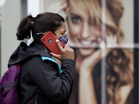 A pedestrian wearing a COVID-19 protective face mask, makes their way along 102 Avenue near 124 Street, in Edmonton Wednesday July 21, 2021.