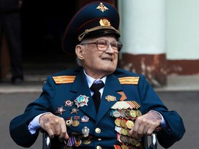 World War Two veteran Nikolay Bagayev, 102, leaves a hospital after being treated for the coronavirus disease (COVID-19) and discharged, in Korolyov, Moscow region, Russia July 22, 2021.