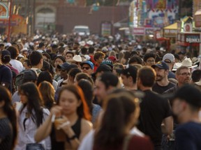 Crowd on the food booth alley on the midway at the Calgary Stampede on Tuesday, July 13, 2021. Mike Drew/Postmedia