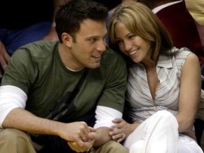 Ben Affleck gets a smile from girlfriend Jennifer Lopez during the Los Angeles Lakers San Antonio Spurs NBA Western Conference semifinal in Los Angeles May 11, 2003.