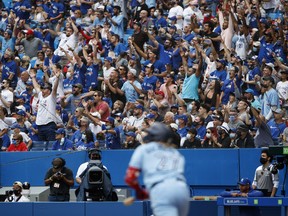 Fans watch as Vladimir Guerrero Jr. #27 of the Toronto Blue Jays hits a deep fly out against the Kansas City Royals during the eight inning of their MLB game at Rogers Centre on July 31, 2021 in Toronto.