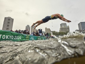 Flora Duffy, of Team Bermuda, dives into the water during the women's individual triathlon at the Tokyo 2020 Olympic Games at Odaiba Marine Park on July 27, 2021, in Tokyo, Japan.