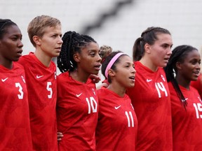 Kadeisha Buchanan Quinn, left, Ashley Lawrence, Desiree Scott, Vanessa Gilles, and Nichelle Prince of Canada stand for the national anthem prior to the women's semifinal between USA and Canada at the Tokyo Olympic Games at Kashima Stadium on Aug. 02, 2021 in Kashima, Ibaraki, Japan.