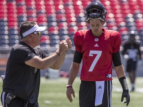Ottawa Redblacks offensive co-ordinator Jaime Elizondo and quarterback Trevor Harris talk during practice in this file photo from TD Place on July 9, 2018. The two have been reunited in Edmonton.