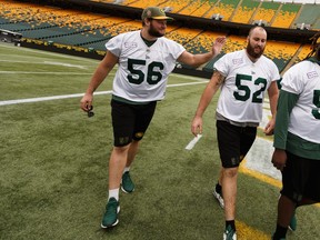Offensive linesmen Kyle Saxelid (56) and Jacob Ruby (52) josh during an Edmonton Elks practice at Commonwealth Stadium in Edmonton, on Friday, Sept. 6, 2019.