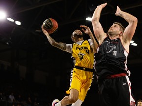 Edmonton Stingers guard Xavier Moon (4) battles Ottawa Blackjacks’ Chad Posthumus (11) in their semi-final game at Edmonton Expo Centre on Friday, Aug. 20, 2021.