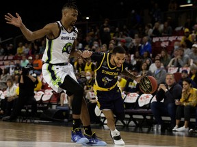 Edmonton Stingers' Xavier Moon (4) battles the Niagara River Lions' Javin Delaurier (12) during the the Canadian Elite Basketball League championship final at the Edmonton Expo Centre on Sunday, Aug. 22, 2021.