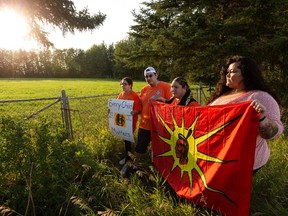 (Left to right) Ocean Sauvee, Kipp Morin, Lorelei Mullings and Andrea Jenkins will hold a multiday vigil at Enoch Cree Nation next to an unmarked gravesite where people from the Northwest Territories and northern Alberta who died at the Charles Camsell Hospital were buried west of Edmonton, on Tuesday, Aug. 24, 2021. Photo by Ian Kucerak