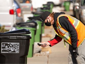 New waste and organics carts are delivered by a city employee in a south Edmonton neighbourhood after a news conference on the Edmonton cart rollout on March 15, 2021.