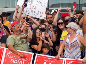 Protesters react while awaiting an election campaign visit by Liberal Prime Minister Justin Trudeau, which was cancelled citing security concerns, in Bolton, Ont., on Aug. 27, 2021.