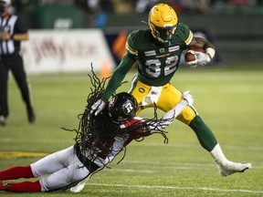 Ottawa Redblacks' Abdul Kanneh (14) tackles Edmonton Elks' James Wilder Jr. (32) in Edmonton on Aug. 7, 2021.